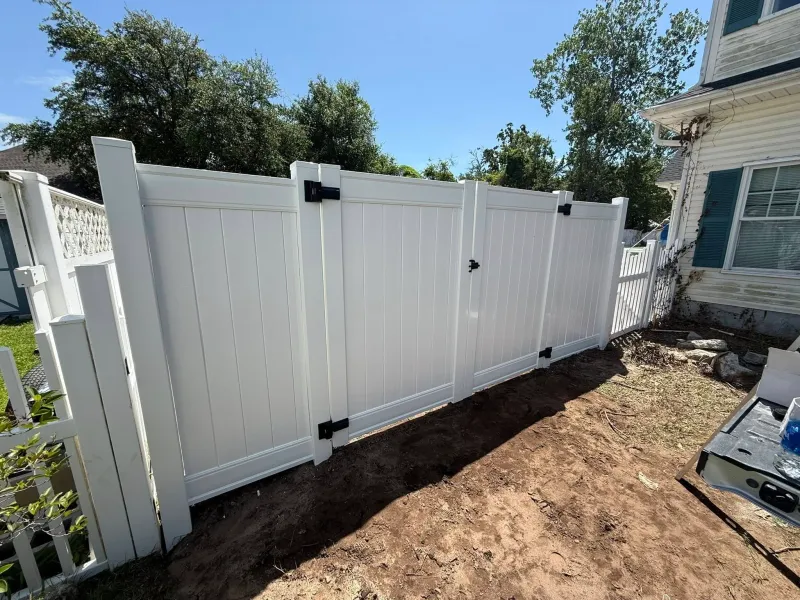 White privacy fence with gate and black hardware