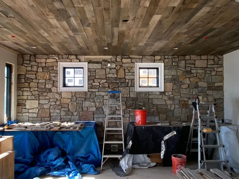 Stone interior wall installation in progress